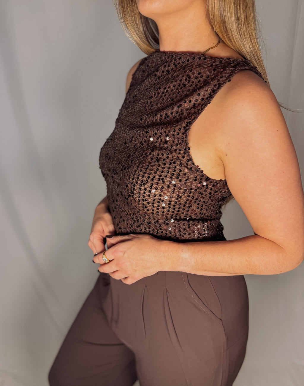Brown sequin top worn by a person on a plain background