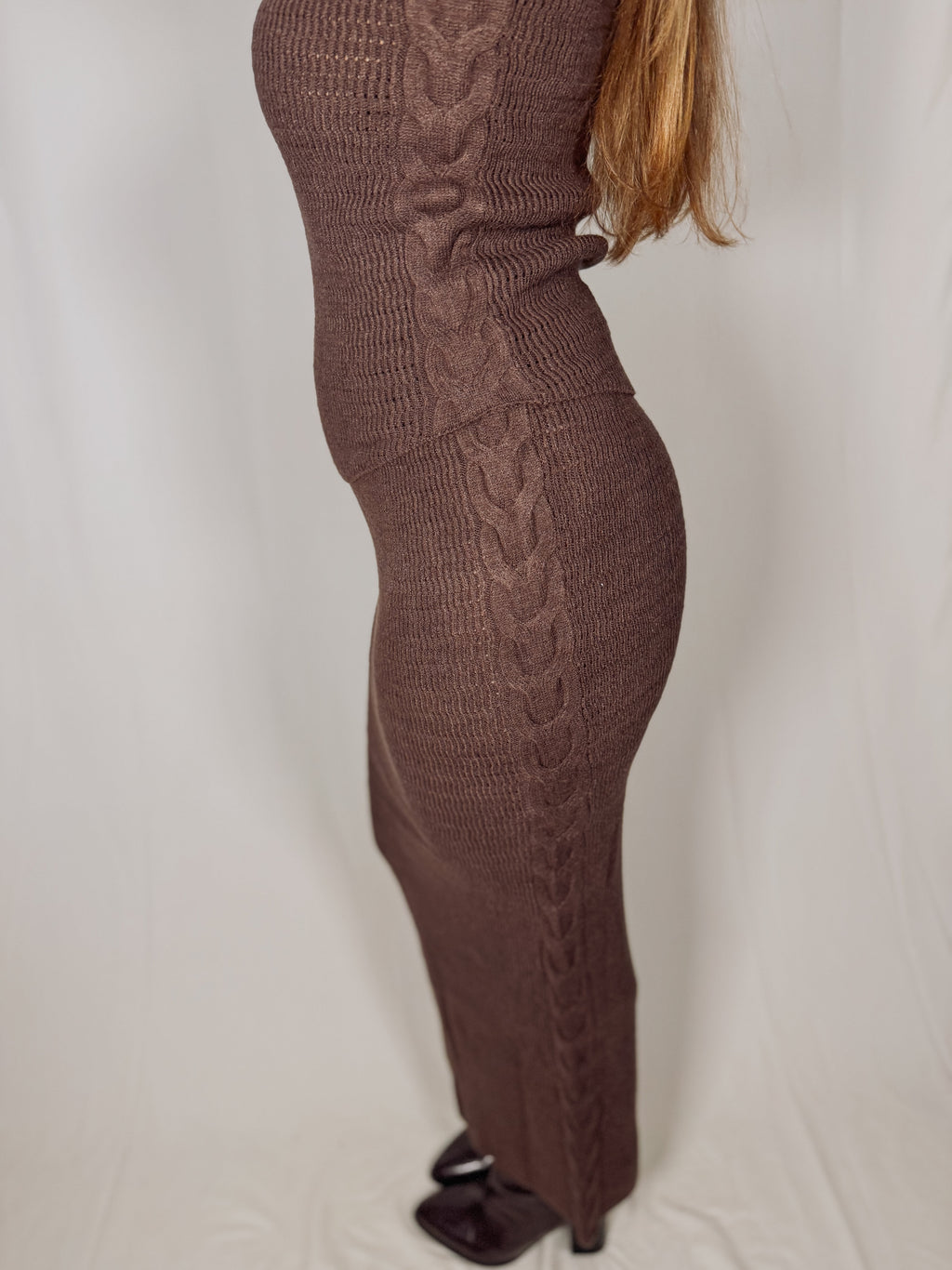Brown cable knit detail on side on a plain background