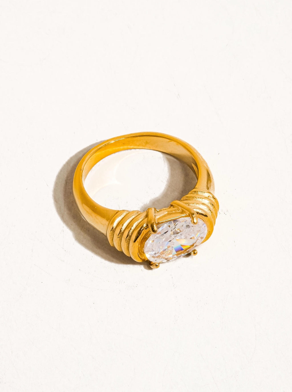 Gold ring with a diamond on a white background