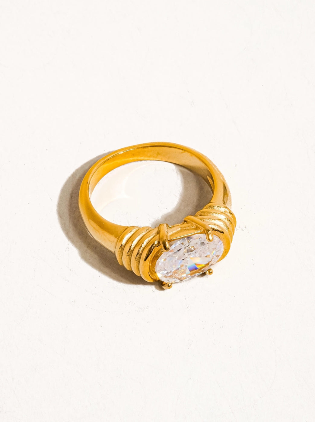 Gold ring with a diamond on a white background